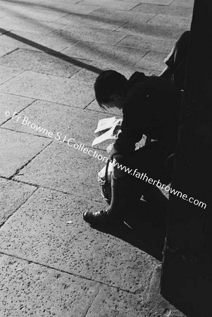 BOY READING AT STATION